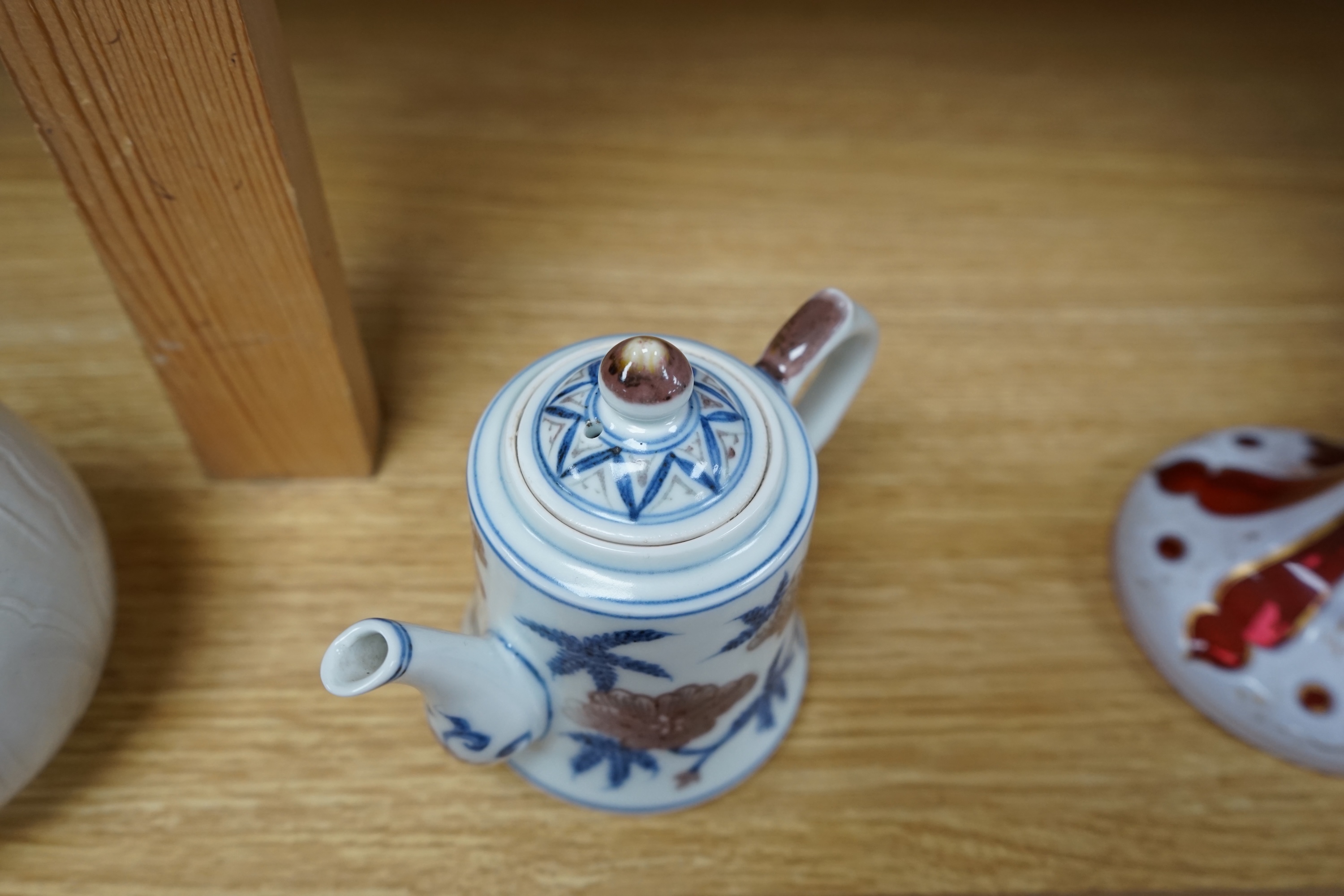 A Chinese carved bottle vase, 18cm high, and a small teapot. Condition - fair to good.